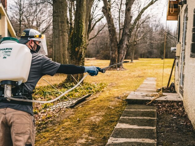 Complete Pest Solutions specialist spraying a yard {{brizy_dc_image_alt entityId=